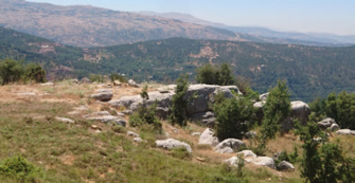 General view towards the west with three burial sites on the left, and two winepress basins to the right. Notice the Beqaata dam in the background